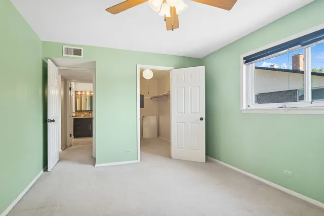 a bathroom with a sink toilet double vanity and shower