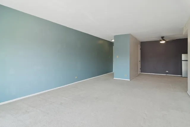 an empty room with closet and windows
