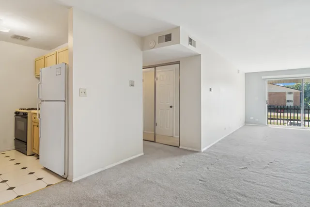 a kitchen with granite countertop a sink a stove and refrigerator