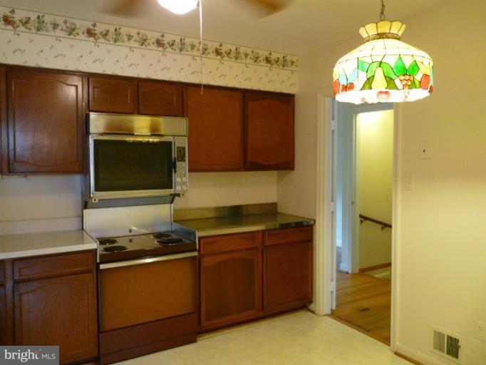 6754 Towne Lane Road McLean, VA 22101 - Photo 1 of 15 a kitchen with a sink and a stove