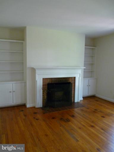 6754 Towne Lane Road McLean, VA 22101 - Photo 2 of 15 a view of empty room with wooden floor and fireplace