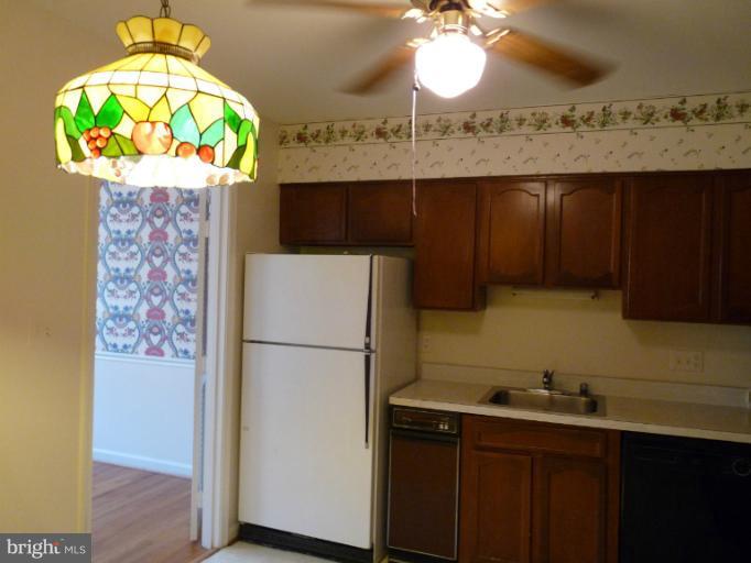 6754 Towne Lane Road McLean, VA 22101 - Photo 4 of 15 a kitchen with a refrigerator and a table