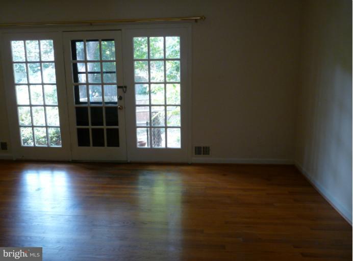 6754 Towne Lane Road McLean, VA 22101 - Photo 5 of 15 an empty room with wooden floor and windows