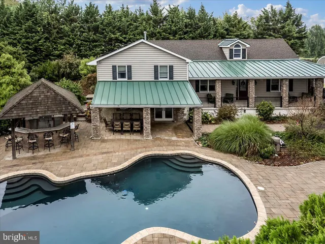 a view of a patio with table and chairs next to a yard