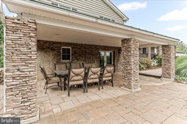 a balcony with furniture and a potted plant
