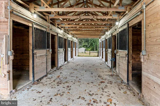 a kitchen with stainless steel appliances kitchen island granite countertop a refrigerator oven a sink dishwasher and a refrigerator with wooden floor