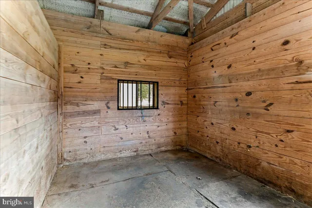a large kitchen with stainless steel appliances kitchen island a large counter top and a wooden floors