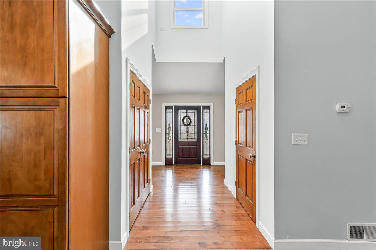 756 Ewing Road Cochranville, PA 19330 - Photo 31 of 73 a view of a hallway with wooden floor and staircase