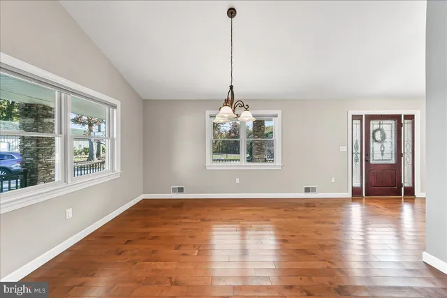 an empty room with a window and a ceiling fan