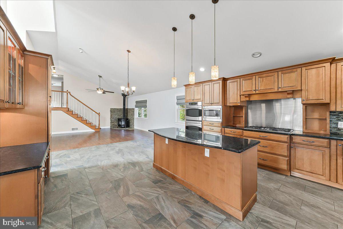 756 Ewing Road Cochranville, PA 19330 - Photo 39 of 73 a large kitchen with stainless steel appliances granite countertop a stove a sink and a refrigerator