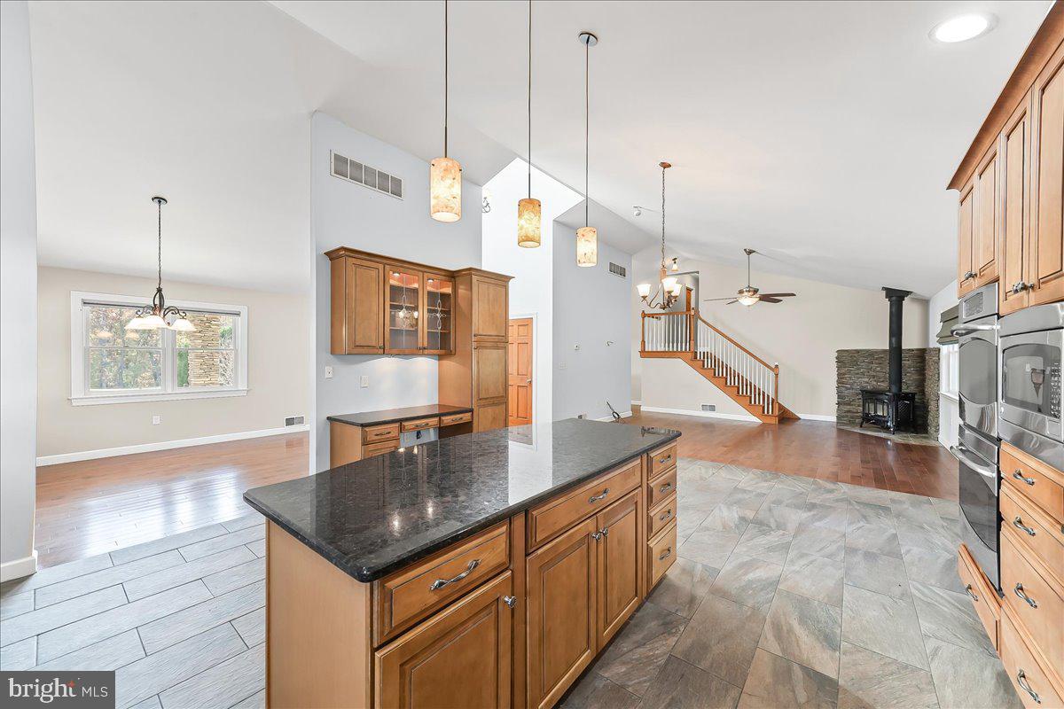 756 Ewing Road Cochranville, PA 19330 - Photo 40 of 73 a kitchen with stainless steel appliances granite countertop a sink a refrigerator and a stove
