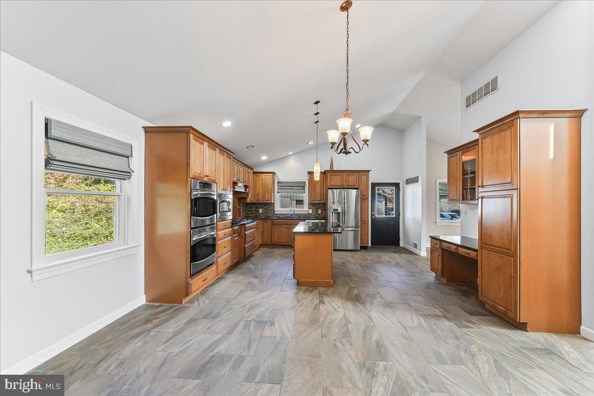 756 Ewing Road Cochranville, PA 19330 - Photo 43 of 73 a large kitchen with stainless steel appliances lots of counter space and wooden floor