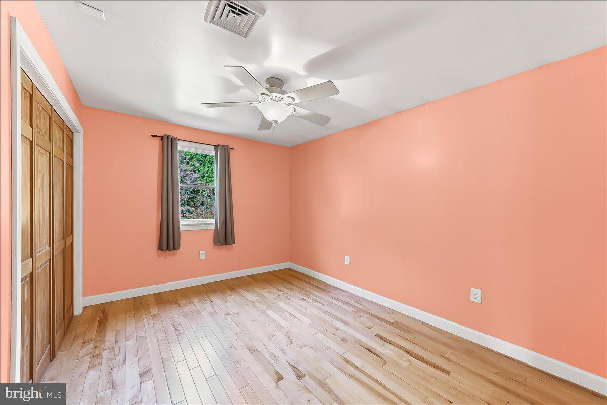 756 Ewing Road Cochranville, PA 19330 - Photo 50 of 73 an empty room with a window and a ceiling fan