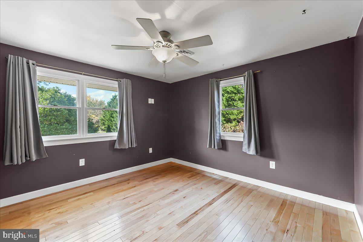 756 Ewing Road Cochranville, PA 19330 - Photo 51 of 73 a view of an empty room with wooden floor and a window