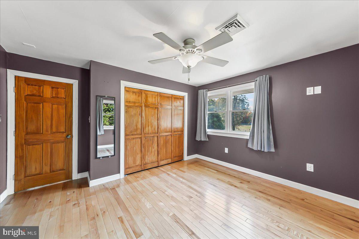 756 Ewing Road Cochranville, PA 19330 - Photo 52 of 73 a view of an empty room with a window and wooden floor