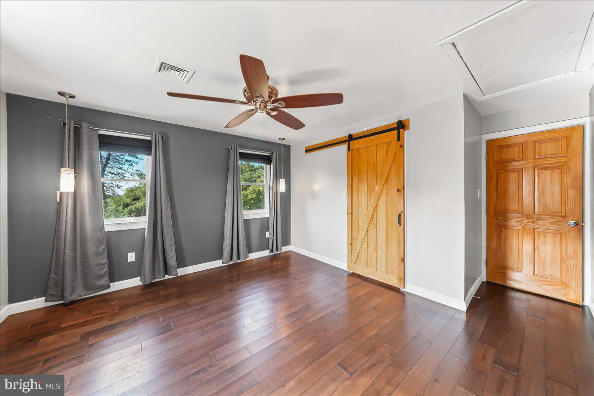 756 Ewing Road Cochranville, PA 19330 - Photo 53 of 73 a view of an empty room with wooden floor and a window