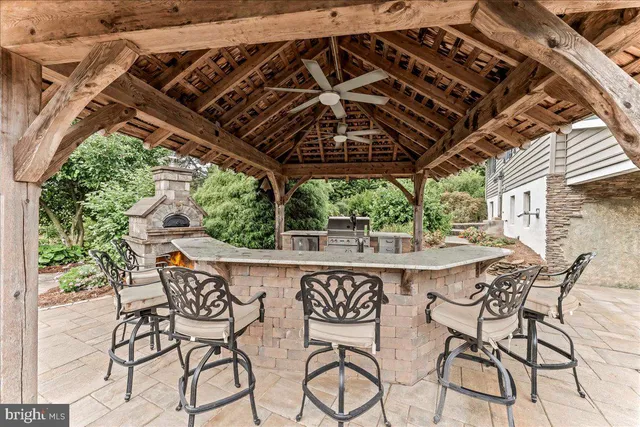 a view of a patio with table and chairs with wooden floor and fence