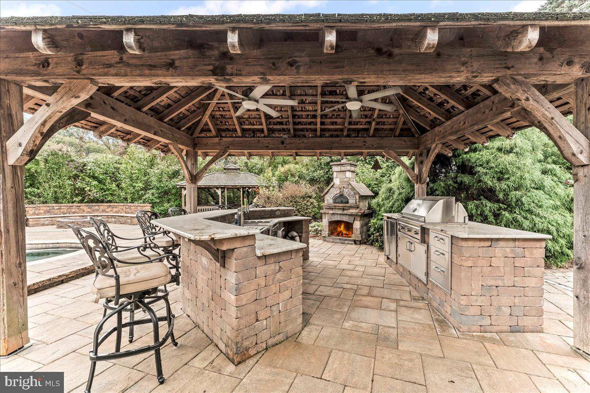 756 Ewing Road Cochranville, PA 19330 - Photo 8 of 73 a view of a patio with table and chairs barbeque with wooden floor