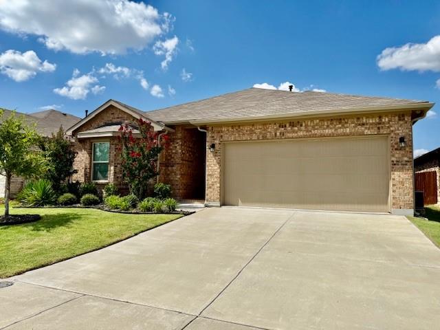 841 Holler Loop Fort Worth, TX 76247 - Photo 1 of 1 a front view of a house with a yard and garage