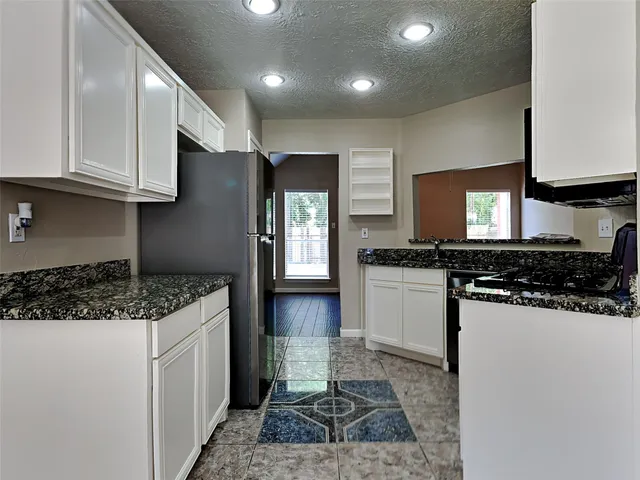 a kitchen with a stove a sink and a refrigerator