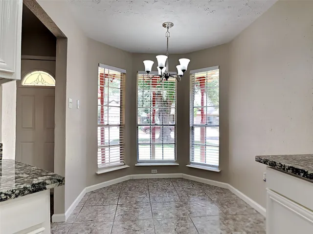a view of a kitchen with granite countertop cabinets and outdoor space