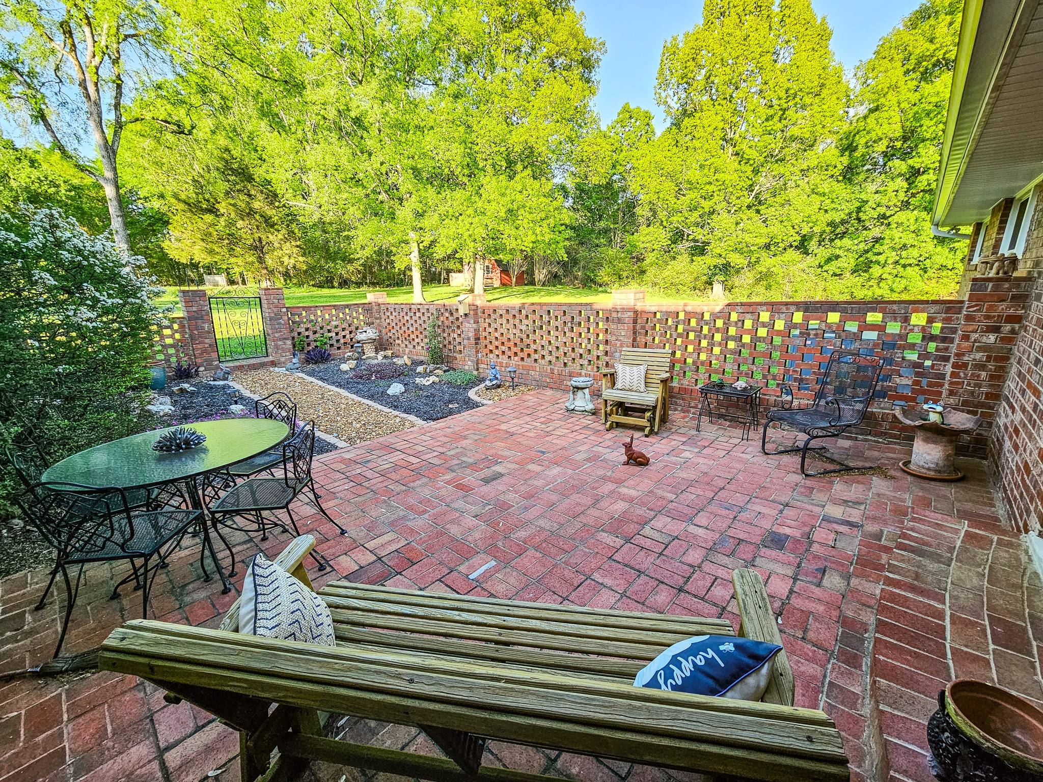 401 South Valley Road Shelbyville, TN 37160 - Photo 7 of 41 The brick patio out the back door with a fountain, rocks, landscaping, and flowers. There are alot of birds that come daily to visit the fountain and area.