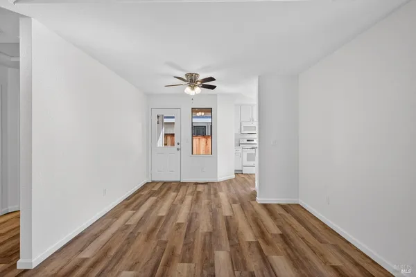 wooden floor in an empty room with a window