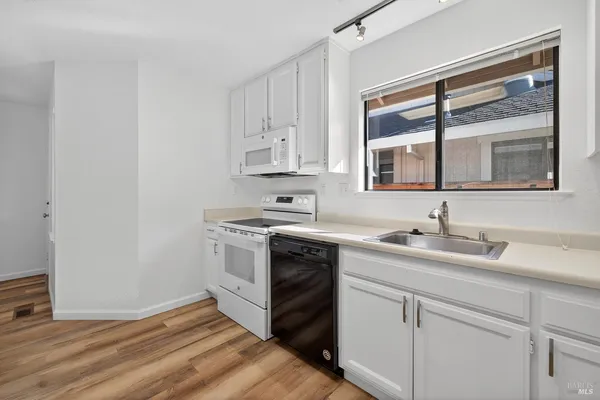 a kitchen with a sink stove and cabinets