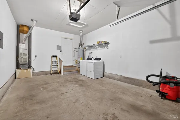 a view of a storage & utility room with two washing machine