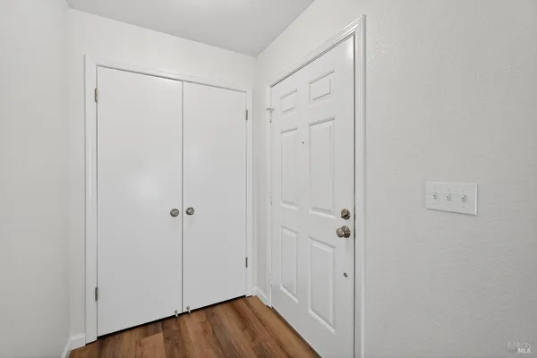 a view of a hallway with wooden floor