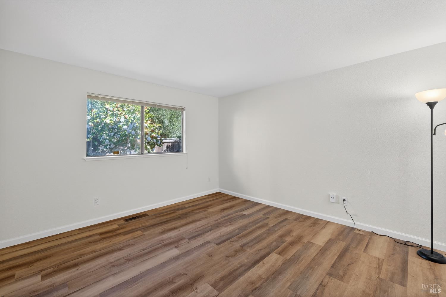663 Spring Lane Sonoma, CA 95476 - Photo 10 of 24 an empty room with wooden floor and windows