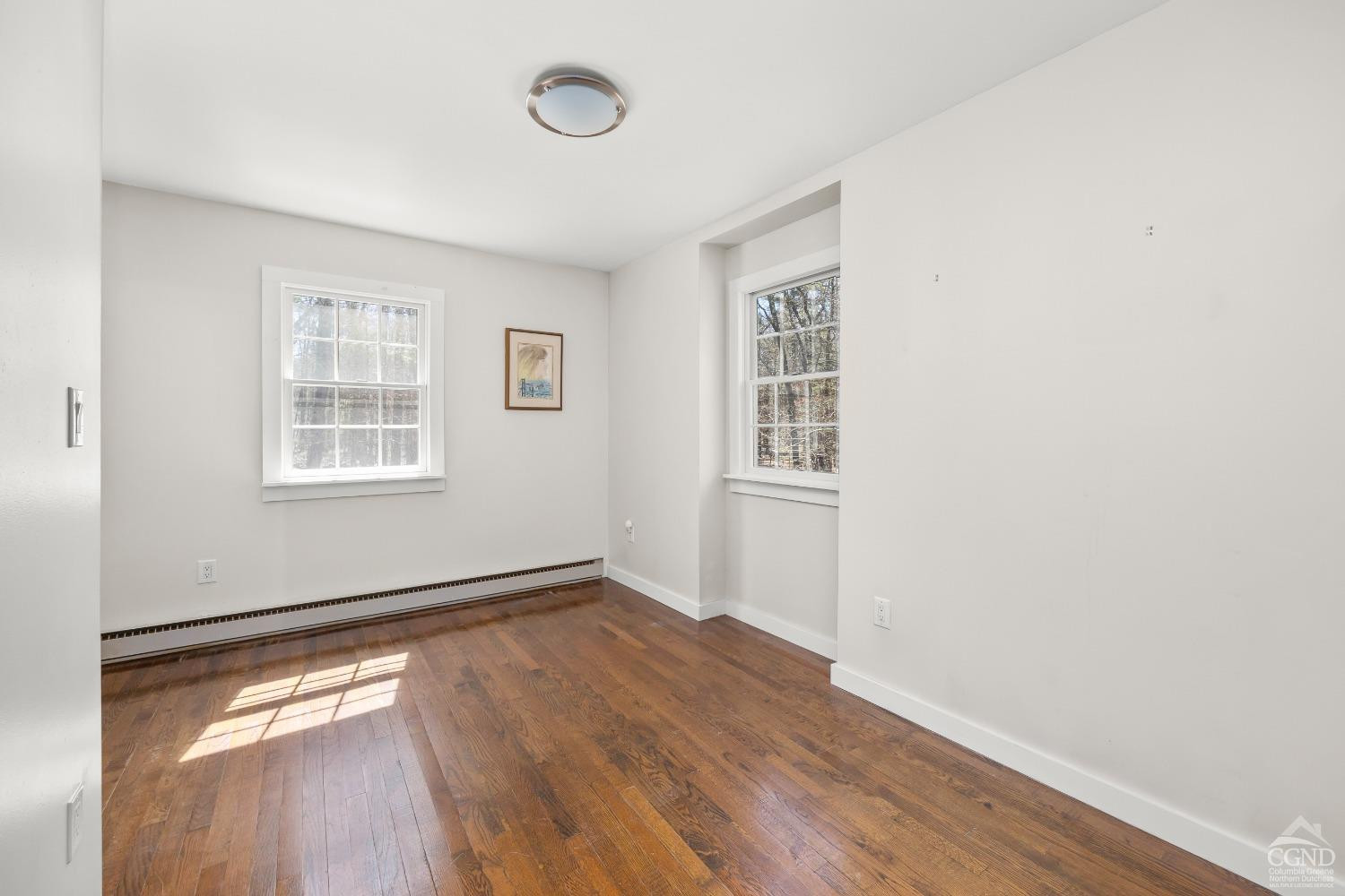 1235 Ira Vail Road Leeds, NY 12451 - Photo 12 of 35 an empty room with wooden floor and windows