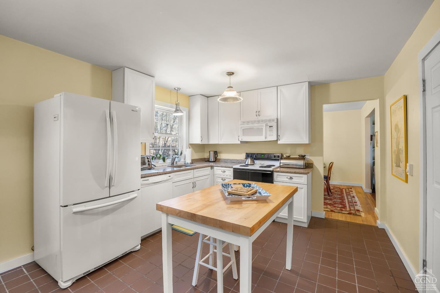 1235 Ira Vail Road Leeds, NY 12451 - Photo 10 of 35 a kitchen with a refrigerator a sink a stove a dining table and chairs