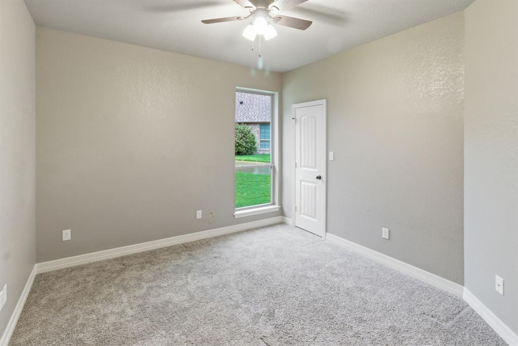 7765 Hickory Spring Lane Tyler, TX 75703 - Photo 28 of 38 Spacious room featuring neutral carpeting, light gray wall paint, and white trim