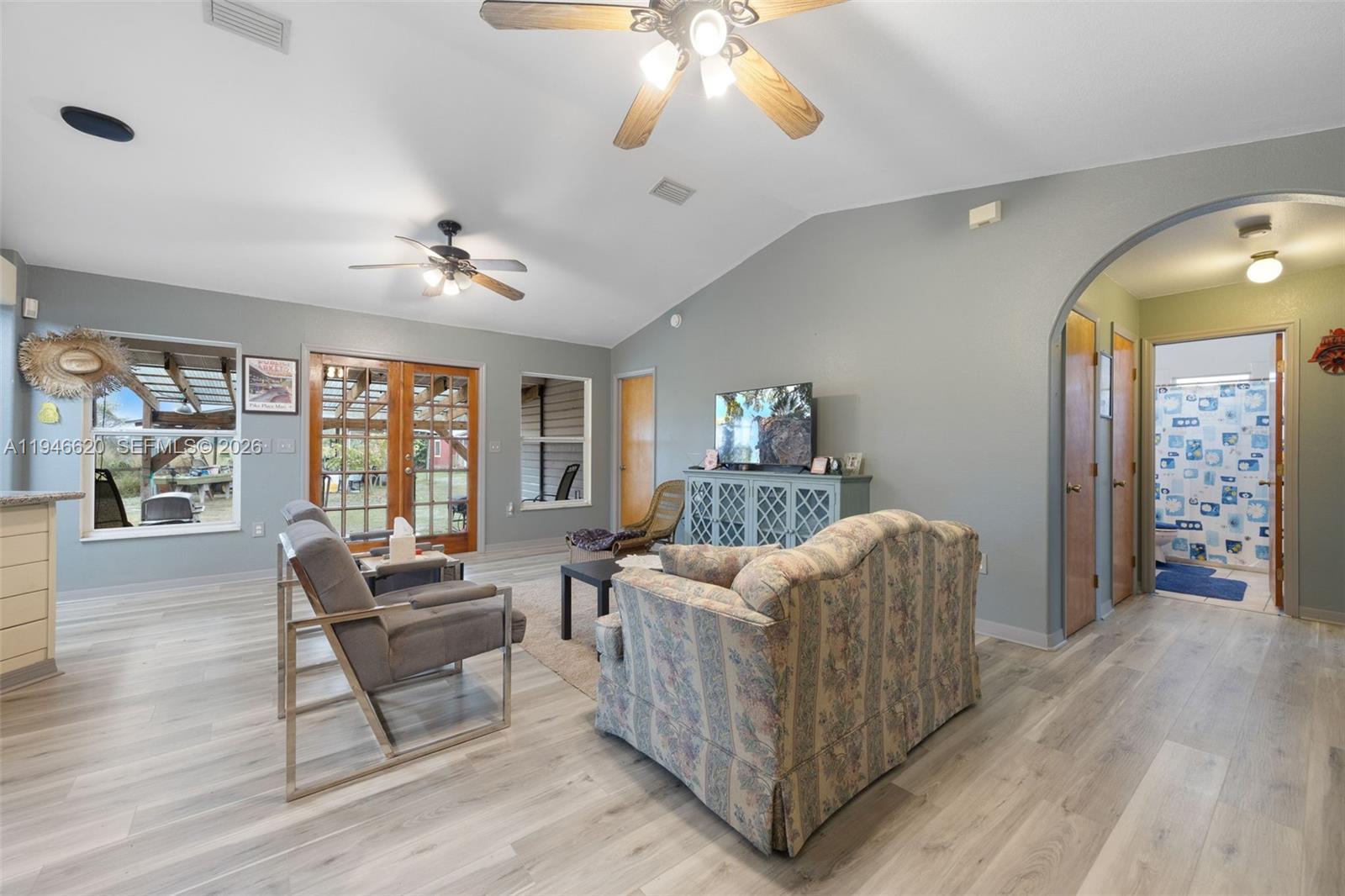 2915 Ortona Locks Road Moore Haven, FL 33471 - Photo 11 of 20 a living room with furniture and a chandelier