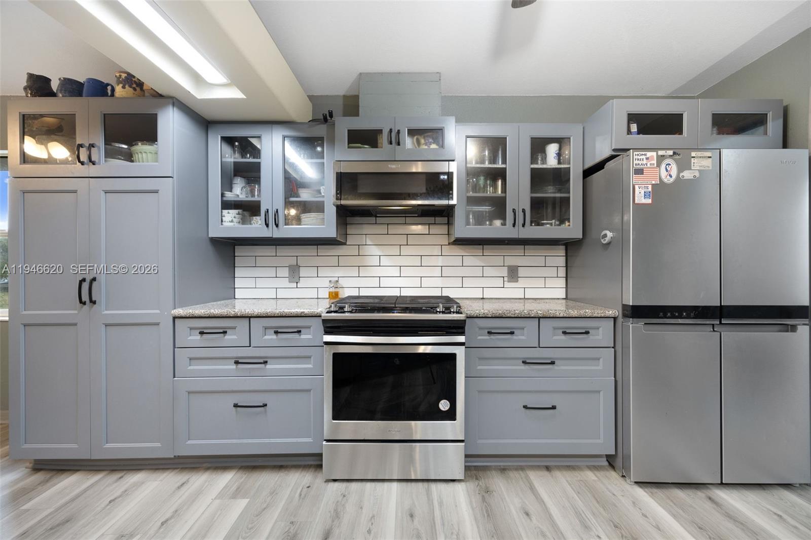 2915 Ortona Locks Road Moore Haven, FL 33471 - Photo 12 of 20 a kitchen with stainless steel appliances cabinets and wooden floor