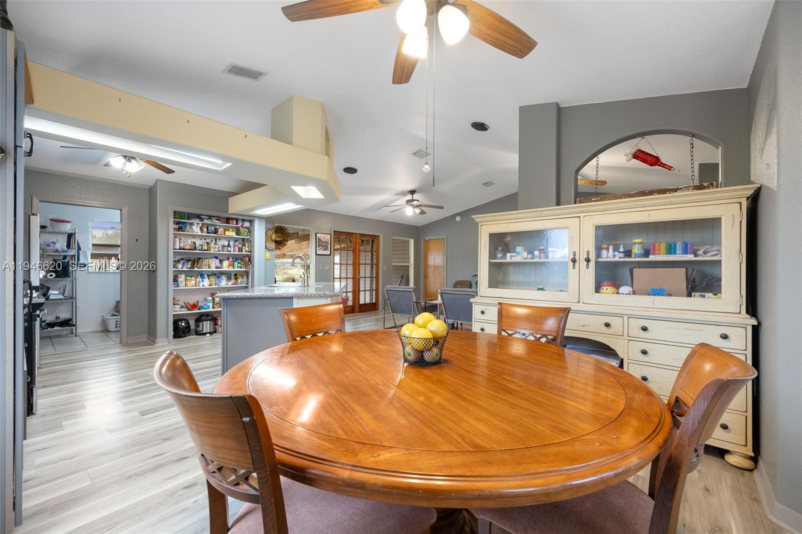 2915 Ortona Locks Road Moore Haven, FL 33471 - Photo 13 of 20 a dining room with furniture and wooden floor