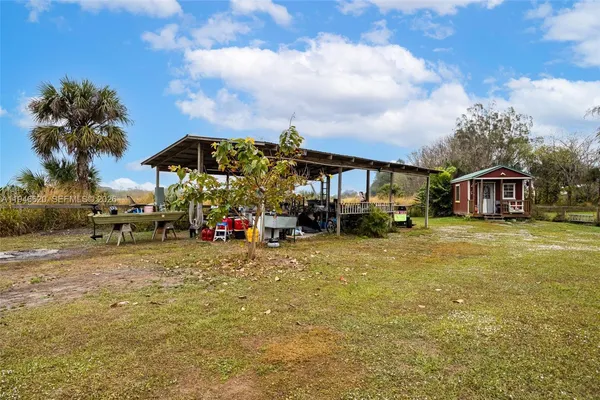 a view of a house with a yard and furniture