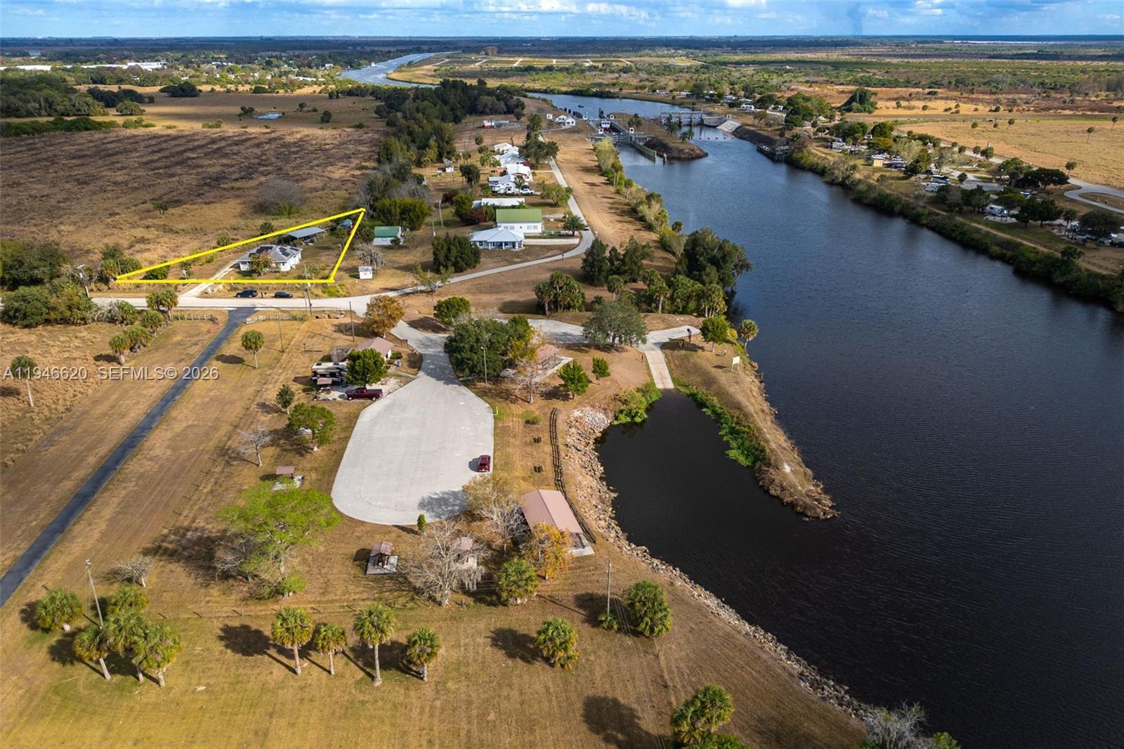 2915 Ortona Locks Road Moore Haven, FL 33471 - Photo 20 of 20 an aerial view of a house with a lake view