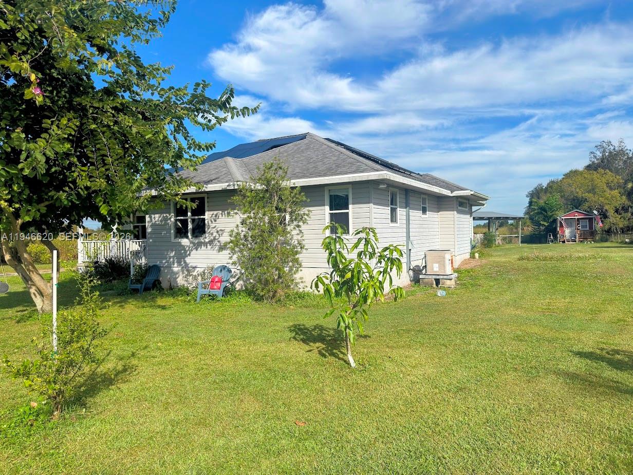 2915 Ortona Locks Road Moore Haven, FL 33471 - Photo 2 of 20 a front view of a house with a yard