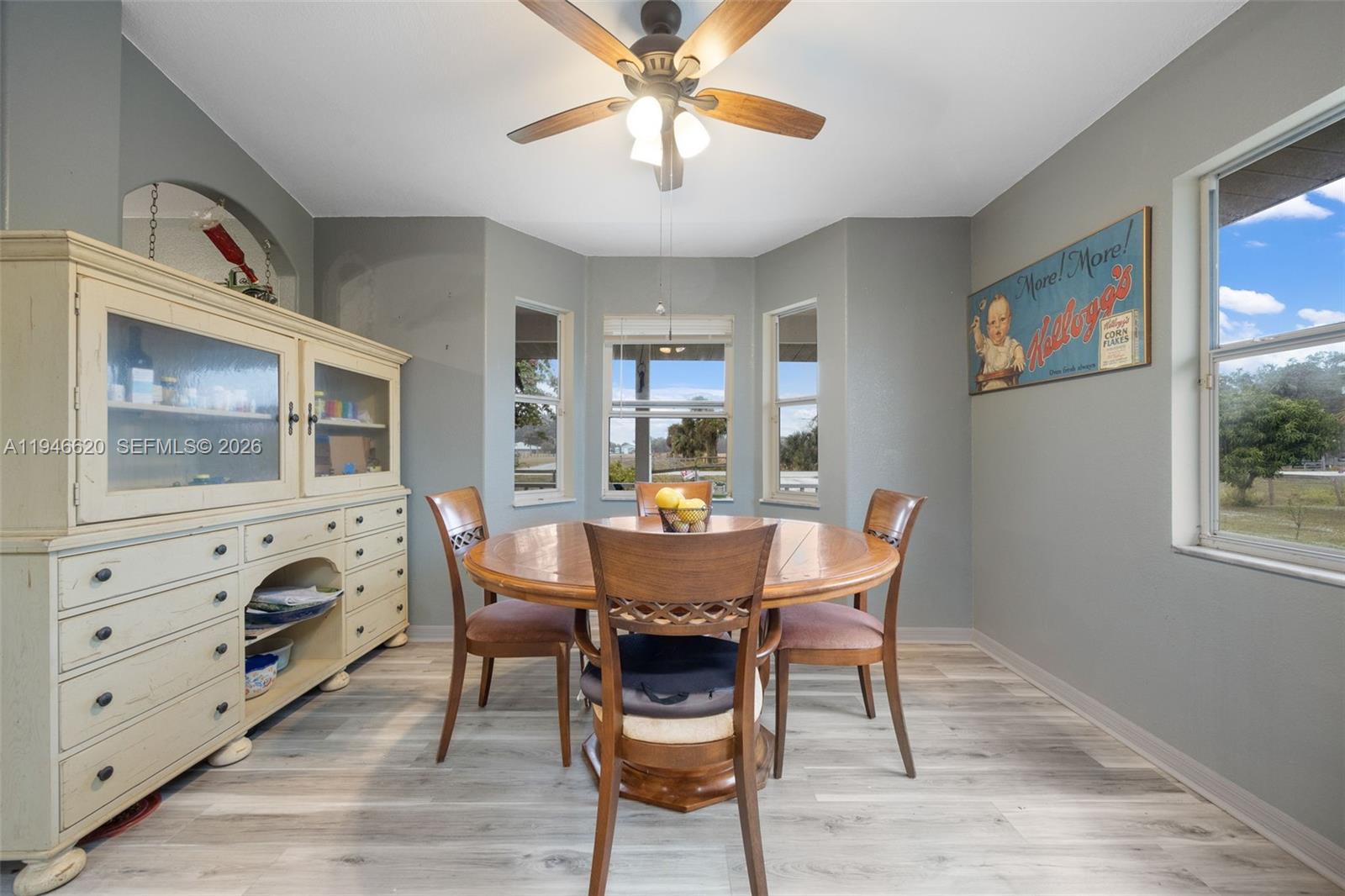 2915 Ortona Locks Road Moore Haven, FL 33471 - Photo 7 of 20 a dining room with furniture a window and wooden floor