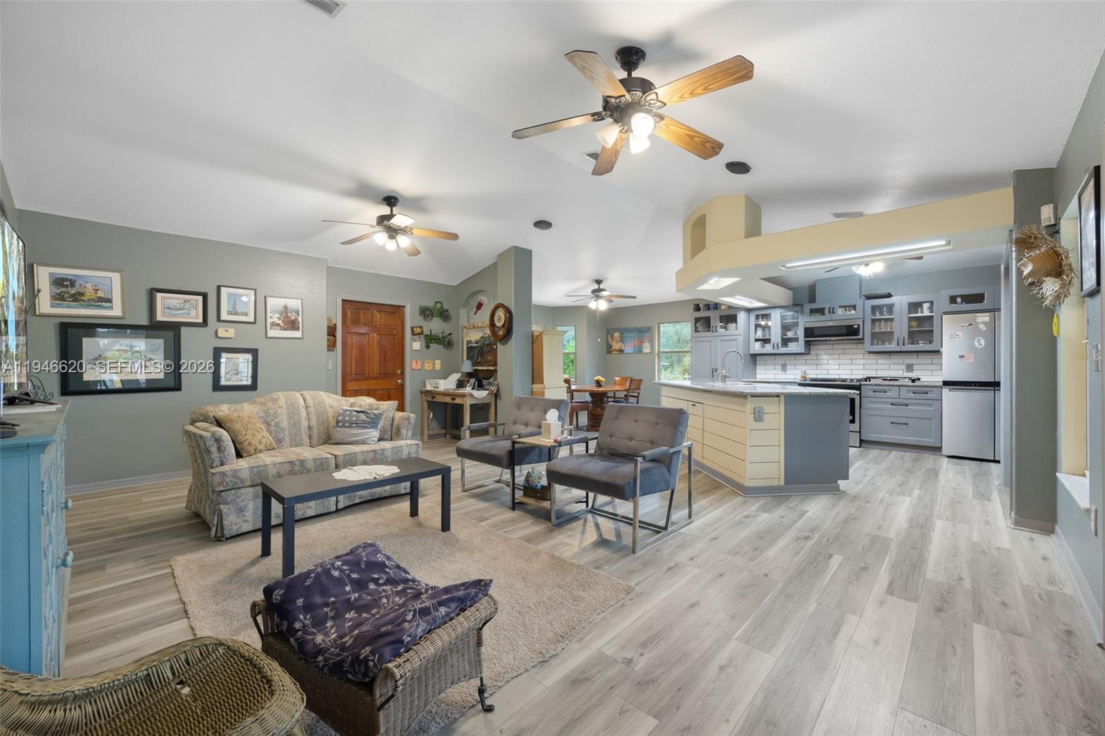 2915 Ortona Locks Road Moore Haven, FL 33471 - Photo 8 of 20 a living room with lots of furniture and kitchen view