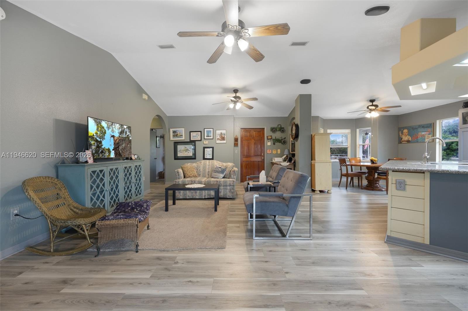 2915 Ortona Locks Road Moore Haven, FL 33471 - Photo 9 of 20 a living room with furniture and a chandelier