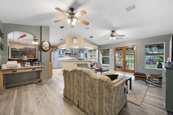 a living room with fireplace furniture and a large window