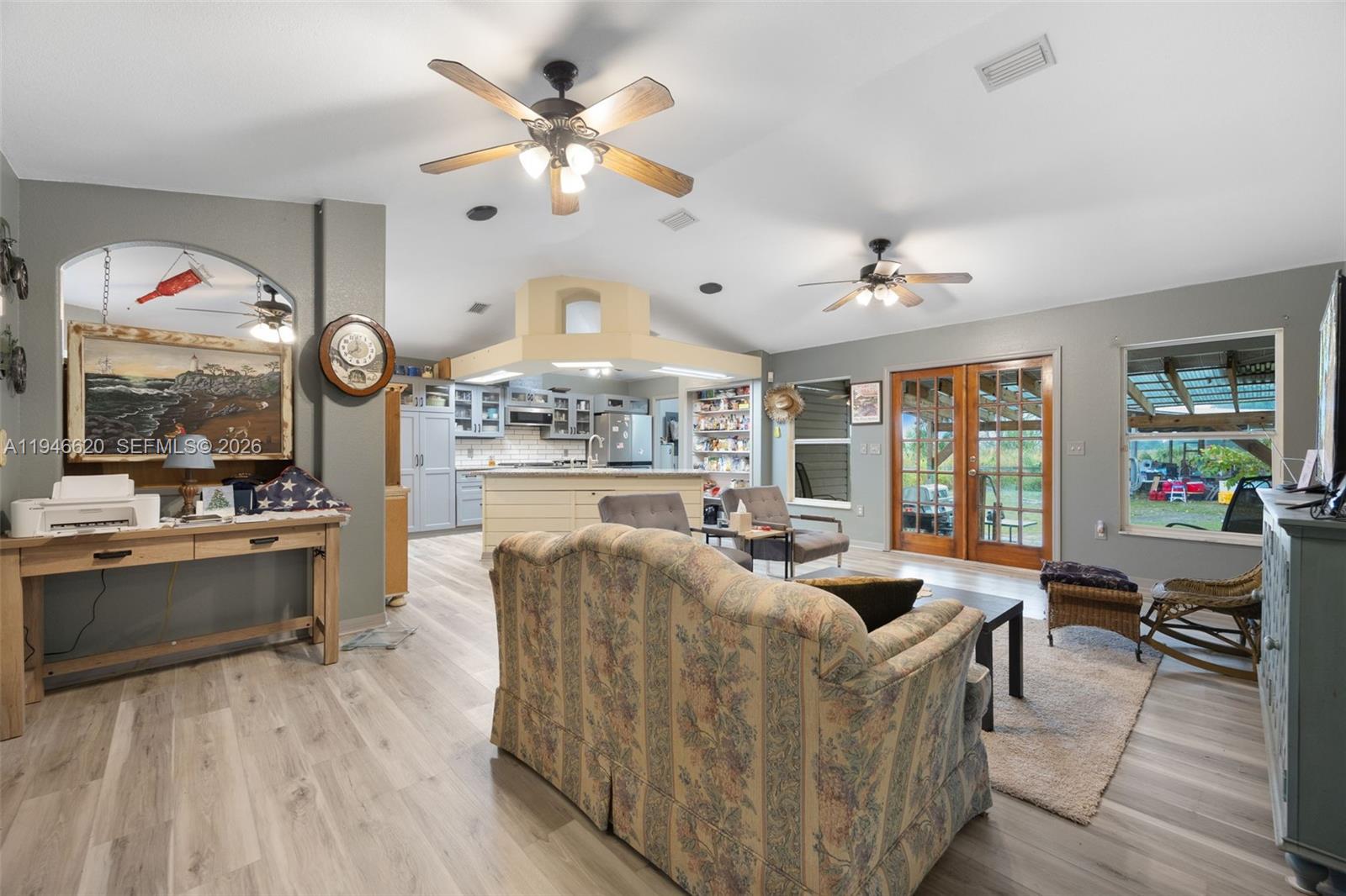 2915 Ortona Locks Road Moore Haven, FL 33471 - Photo 10 of 20 a living room with fireplace furniture and a large window