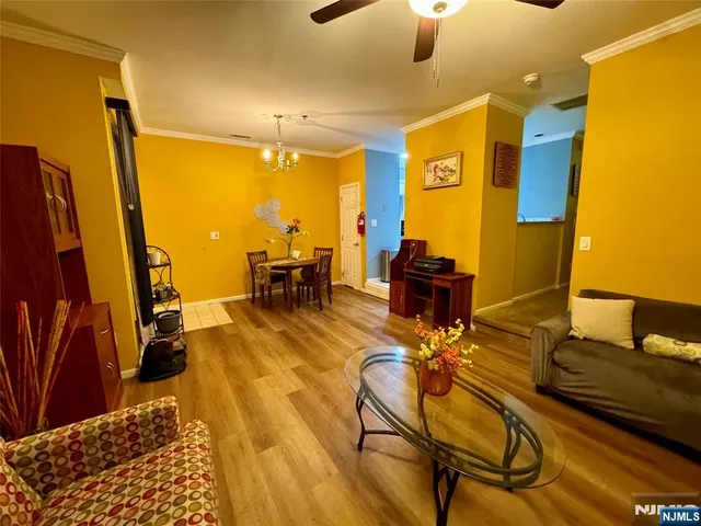 a living room with dining room and wooden floor