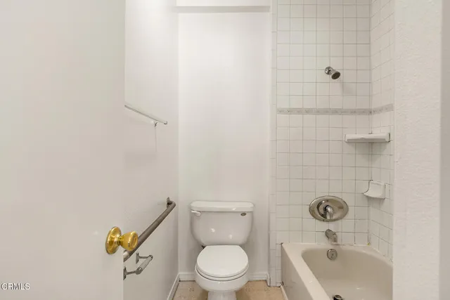 a bathroom with a toilet a sink and shower