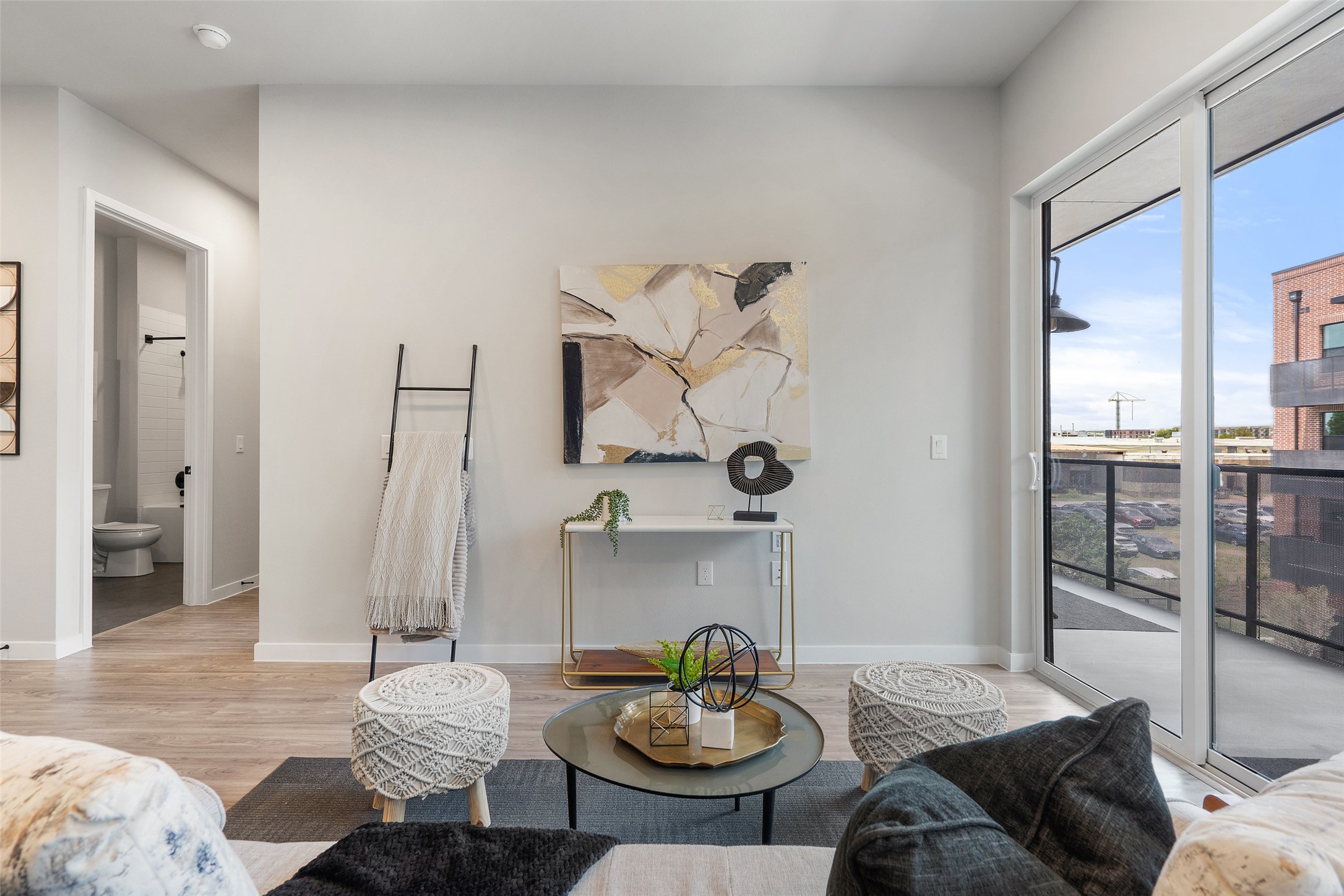 4510 Terry-O Lane, Unit 341 Austin, TX 78745 - Photo 16 of 40 Living area featuring light-colored flooring, light-colored walls, and a sliding glass door leading to a balcony
