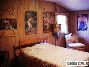 2901 Ferncliff Road Charlotte, NC 28211 - Photo 5 of 8 a bedroom with a bed and a painting on the wall