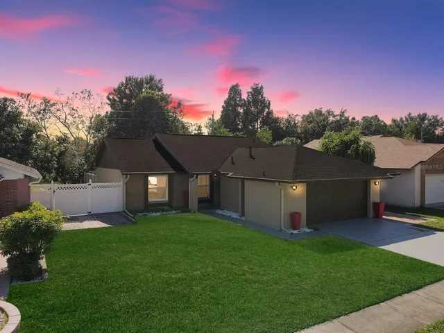 a front view of a house with a garden and yard